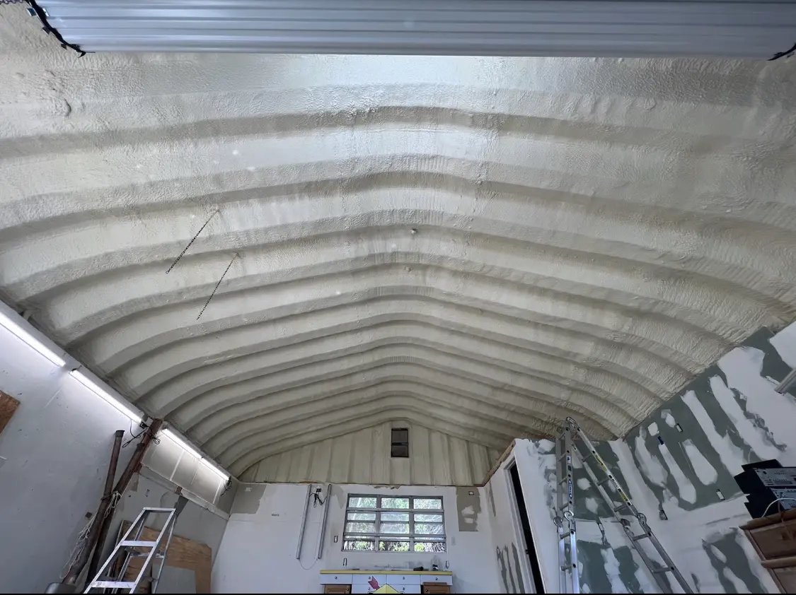 Spray polyurethane foam applied to the underside of a metal roof deck in Woodburn